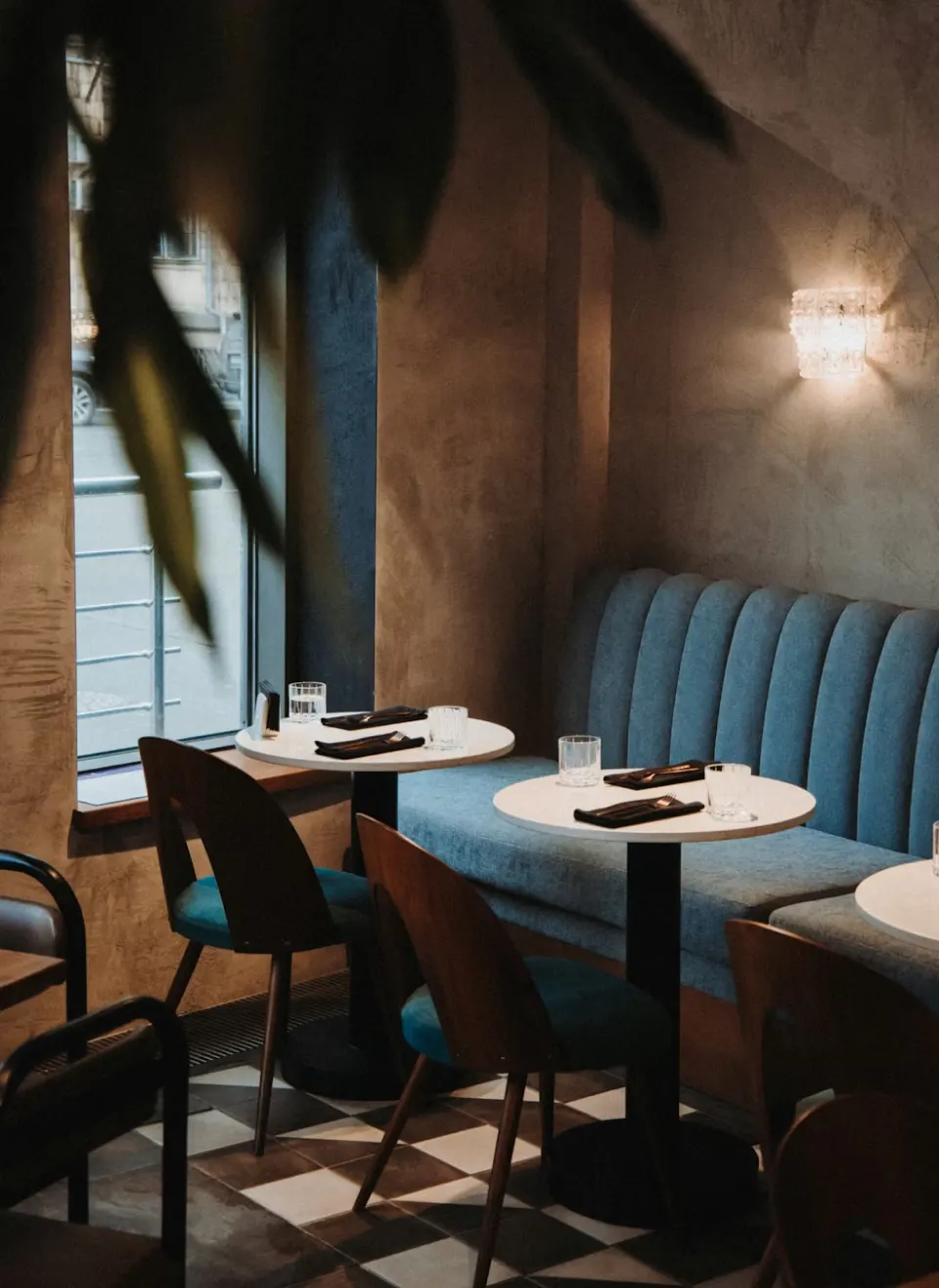 An empty restaurant dining room with booths and small tables