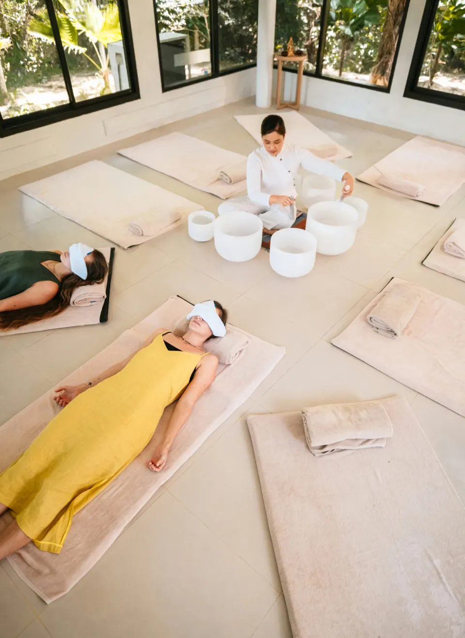 People resting on mats during a sound bath session