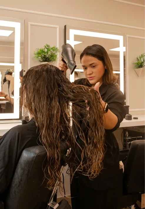 A hairdresser styling a client’s hair